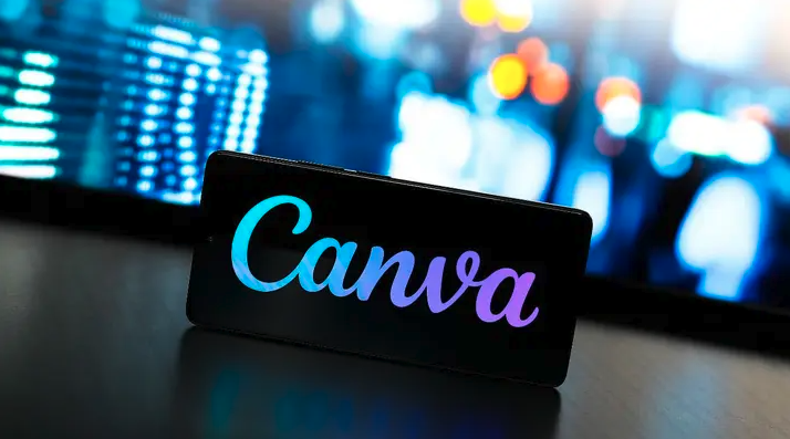 The image shows a logo of canva put on the table in a semi dark room